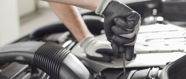 tecnico al lavoro sul vano motore con tester collegato